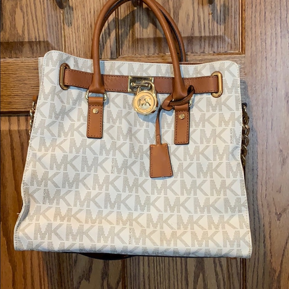 Tan and cream colored Michael Kors cross body bag